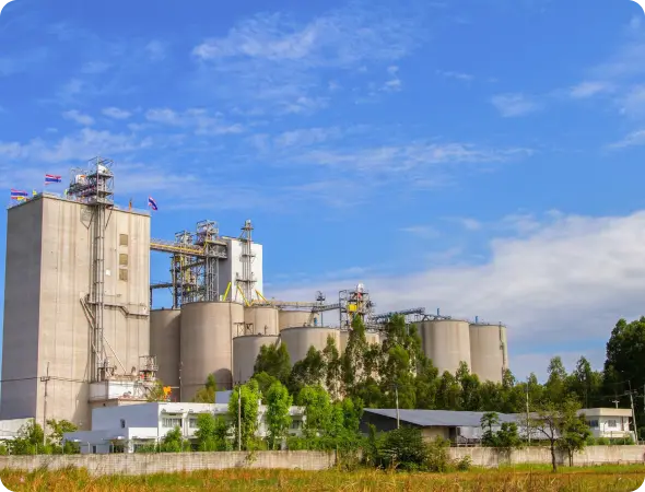 Industrial cement silos storage facility with concrete towers.