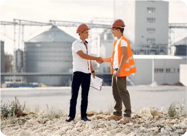Two professionals shaking hands during consultancy services meeting at cement plant